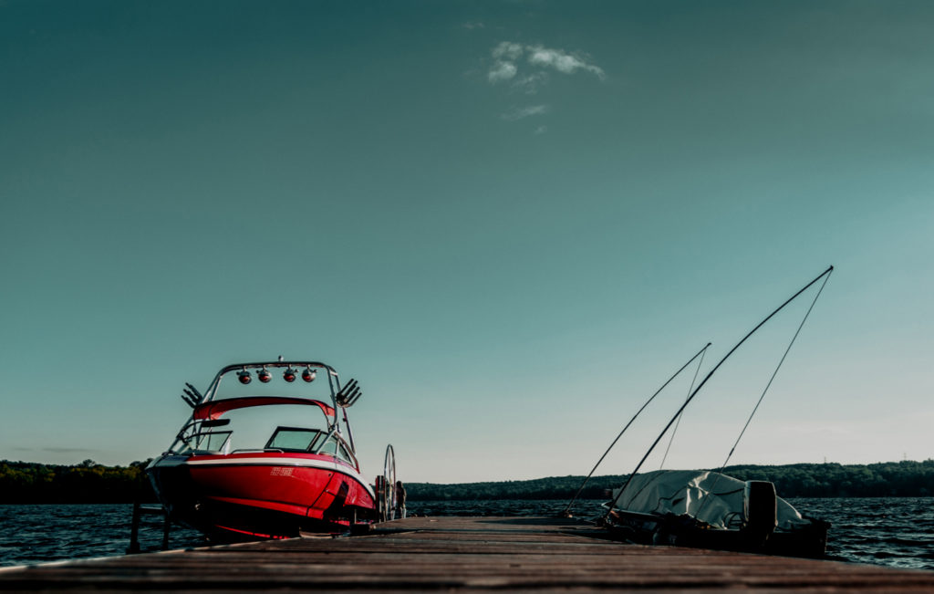 Image of a maintained boat docked on a lake. 