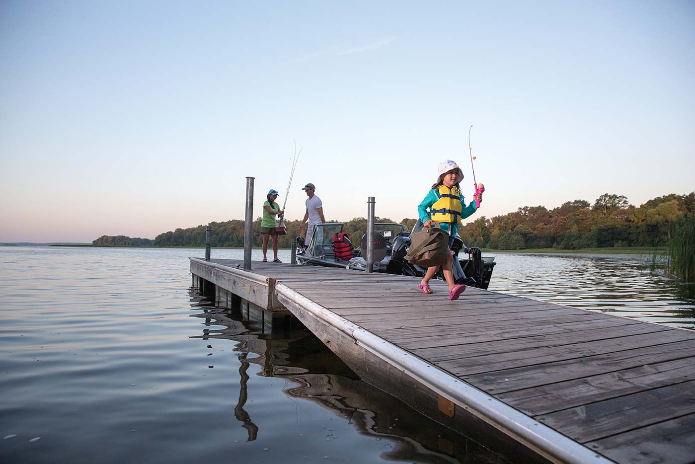 People carrying fishing gear after getting off a boat at a dock, boat in New York concept. 