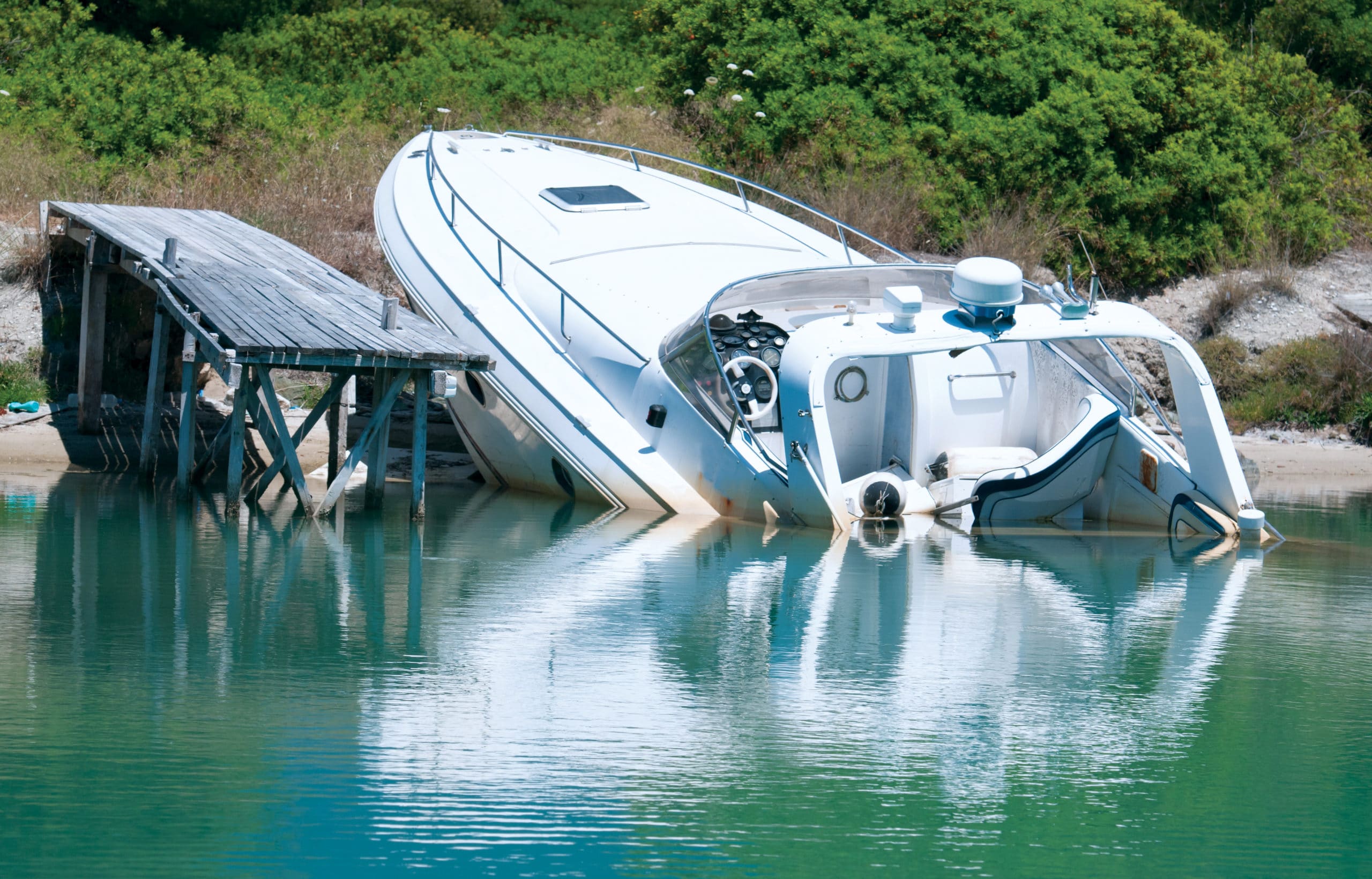 A boat wrecked on the shore, North Dakota boating laws require reporting accidents concept. 