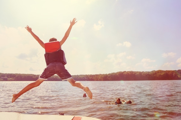 Kids jumping into lake