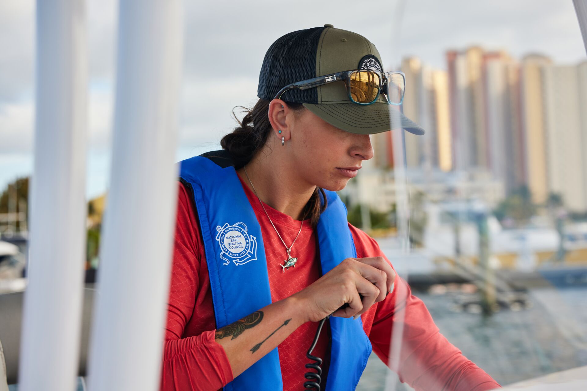 A woman using a radio on a boat, follow New Jersey boating regulations concept.