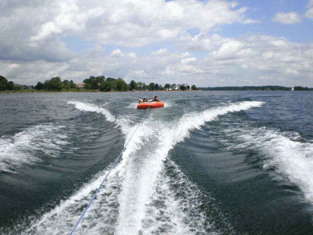 People on an inflatable behind a boat on Lake Norman in North Carolina