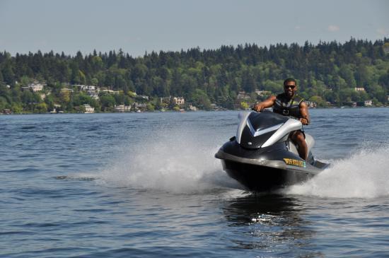 A man enjoying a PWC (personal watercraft) on a lake.