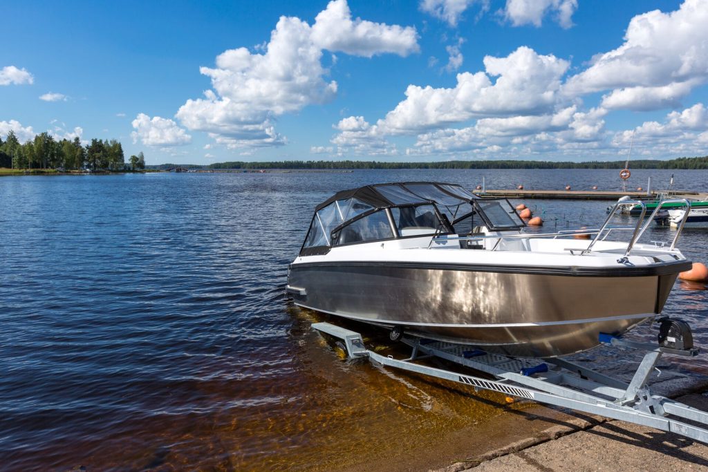A boat being launched into the water from a trailer.