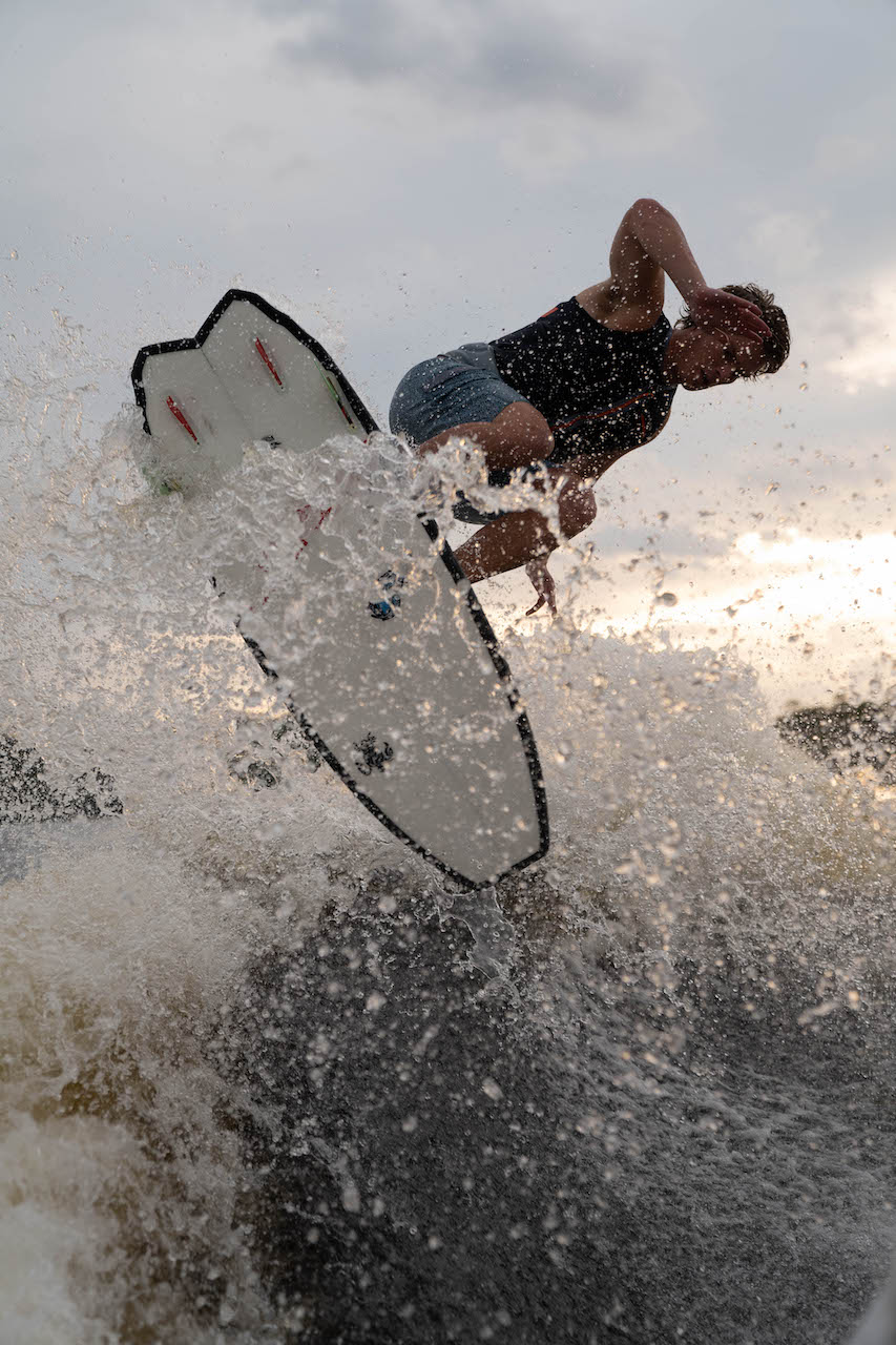Keenan Flegel on a wake board while wake surfing.