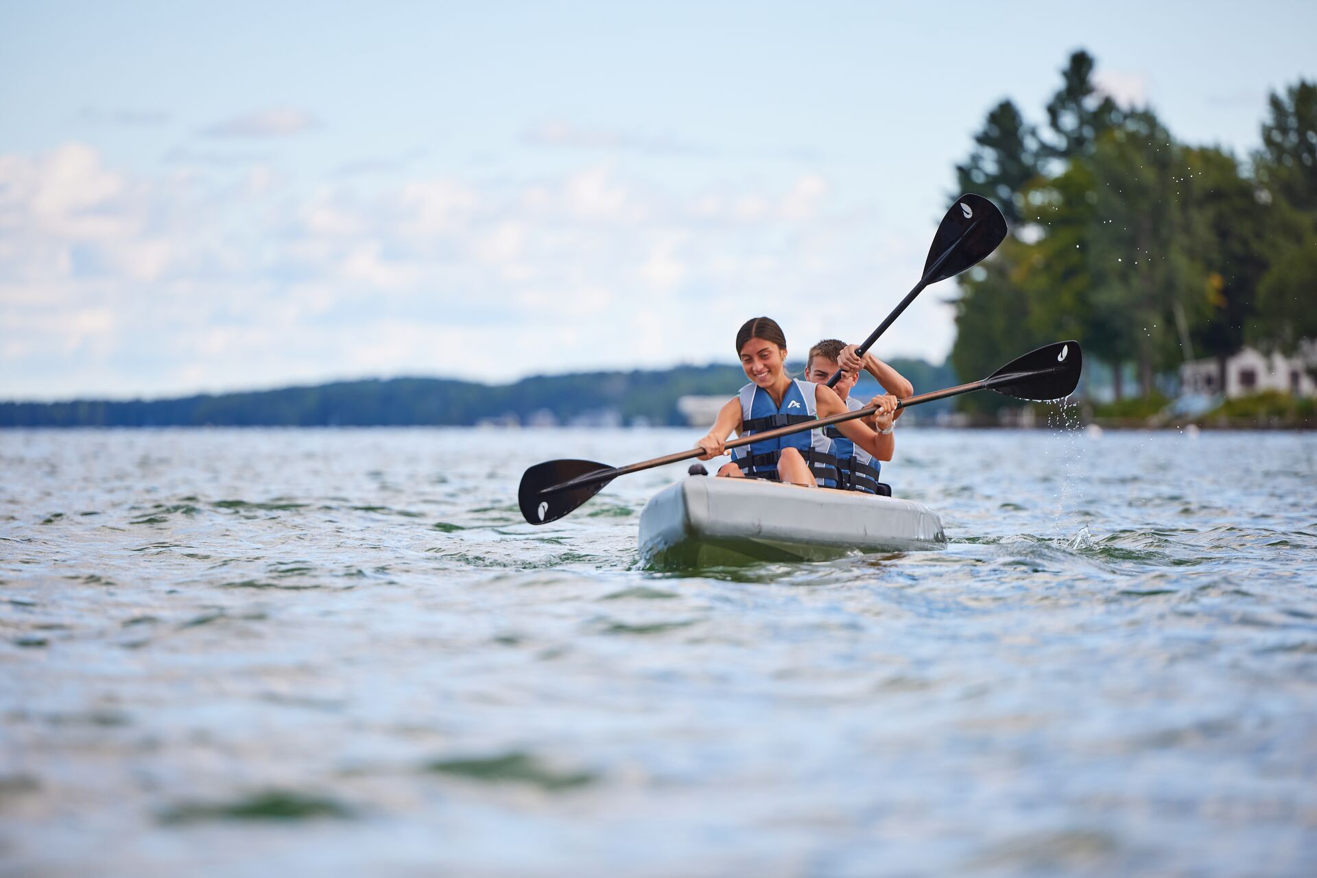 Two people paddling a canoe on the water.