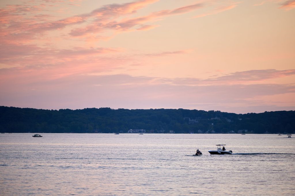 Boats in the distance on a lake at dusk, boating acccess concept.