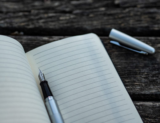 A pen on a blank notebook page, boat maintenance checklist concept.