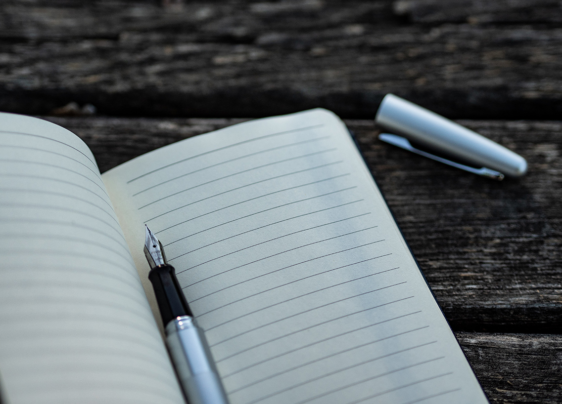 A pen on a blank notebook page, boat maintenance checklist concept.