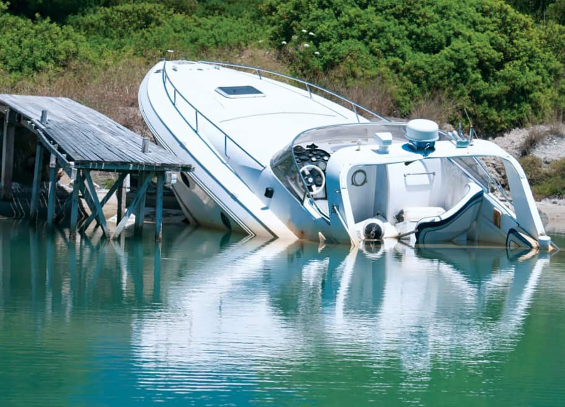 A boat partially submerged in the water near shore, follow Utah boating laws concept. 