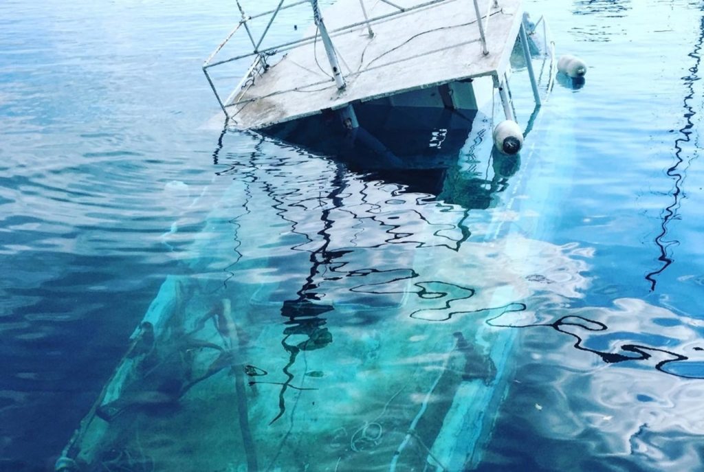A boat wrecked half underwater, can you drink and drive a boat in Texas concept.
