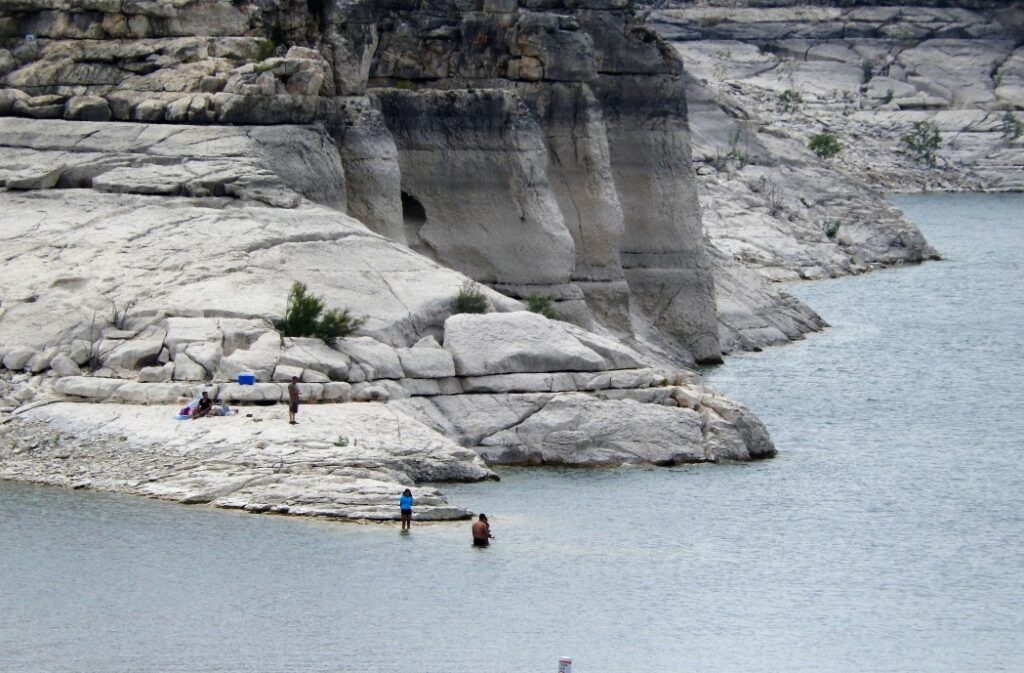 Rocky terrain surrounding Lake Amistad, where to boat in Texas.