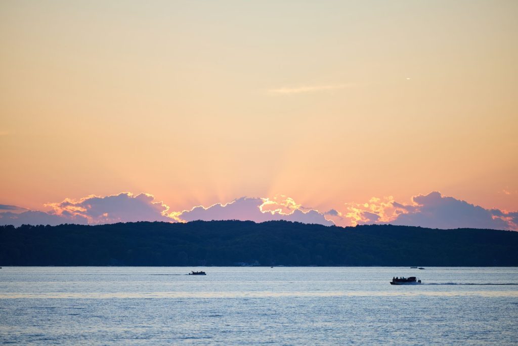 Wide view of two boats on a calm lake, eco-friendly boating concept.