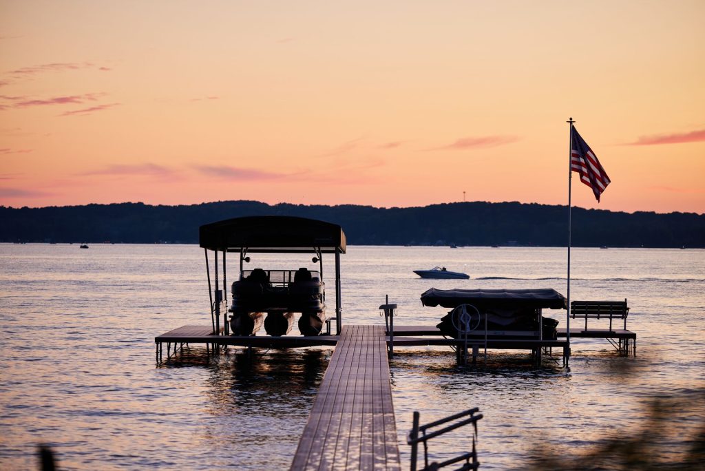 A boat at the dock near a U.S. flag, boating in New York concept.
