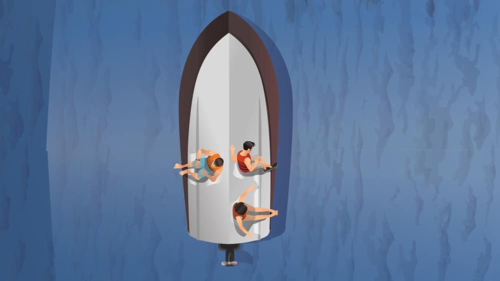 Boaters sitting on top of a capsized boat