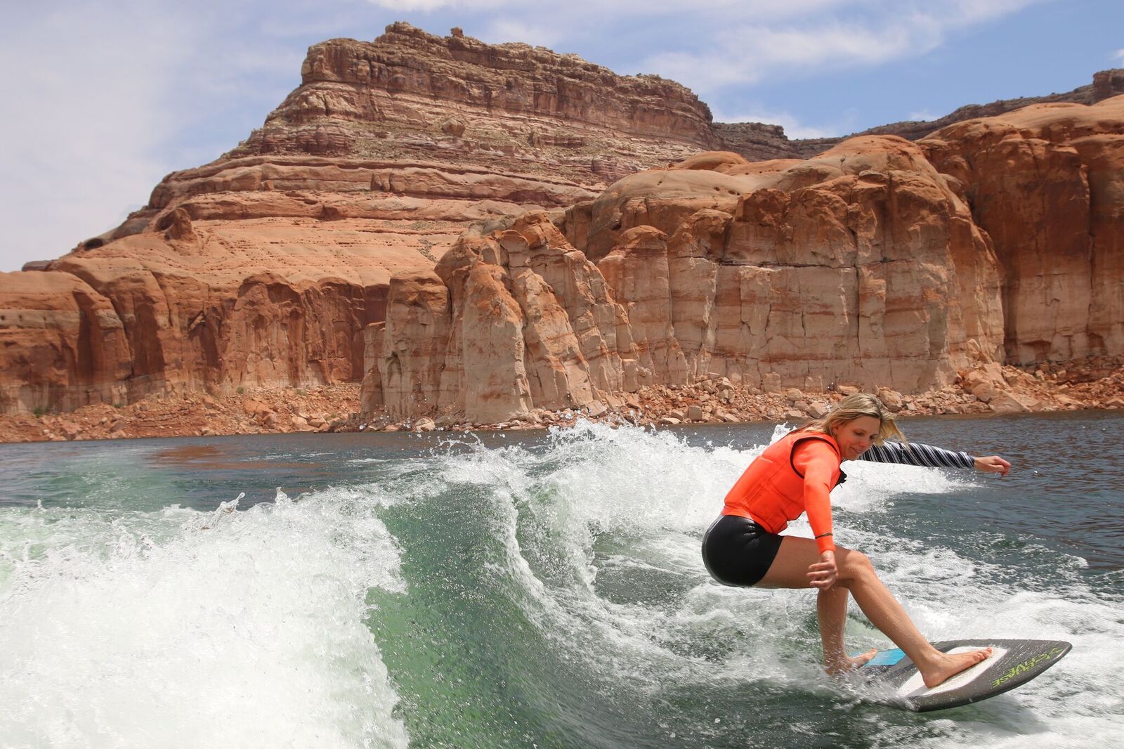 picture of woman surfing - how to extend your boating season
