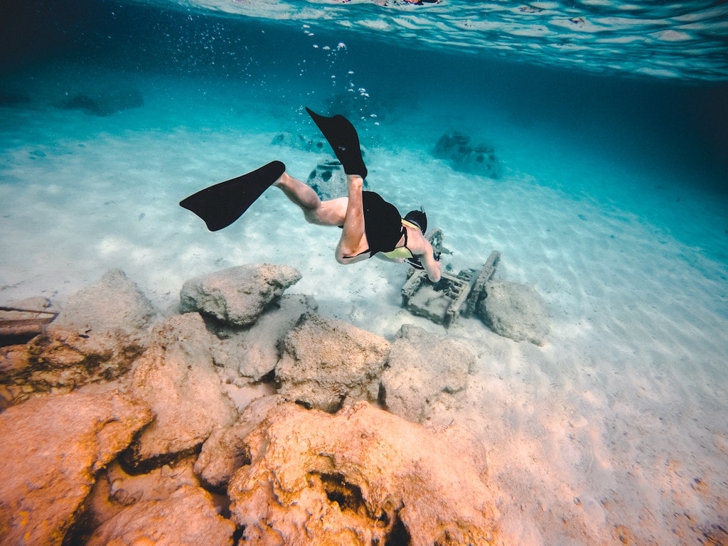 A man scuba diving under water. 