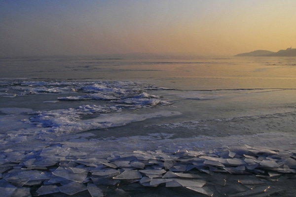 A wide view of melting ice, checking ice conditions before launching a boat concept.