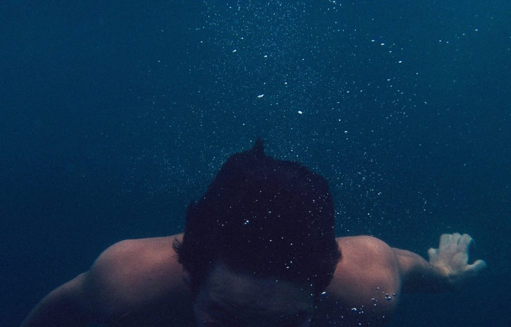 Image of a man underwater - illustration the dangers of drinking and boating. 