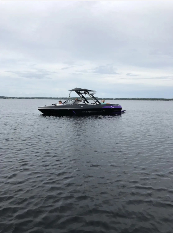 Image of a wakeboarding boat on a lake. 