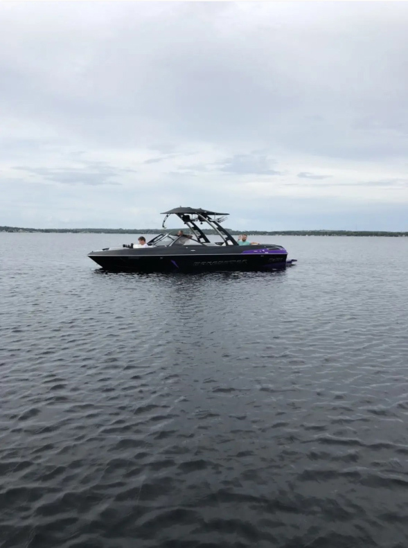 Image of a wakeboarding boat on a lake.