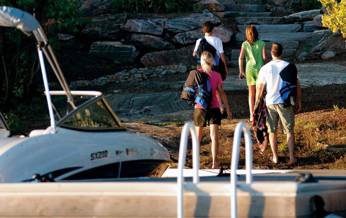 family arriving at cottage via boat