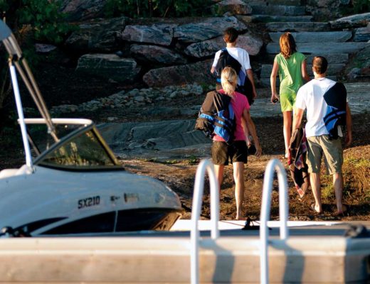 family arriving at cottage via boat