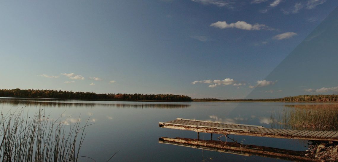 Dock overlooking calm lake in Manitoba