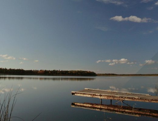 Dock overlooking calm lake in Manitoba