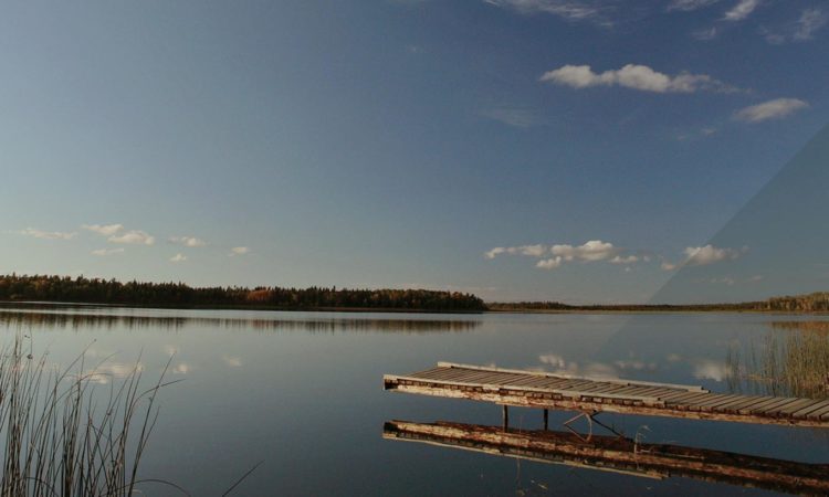 Dock overlooking calm lake in Manitoba